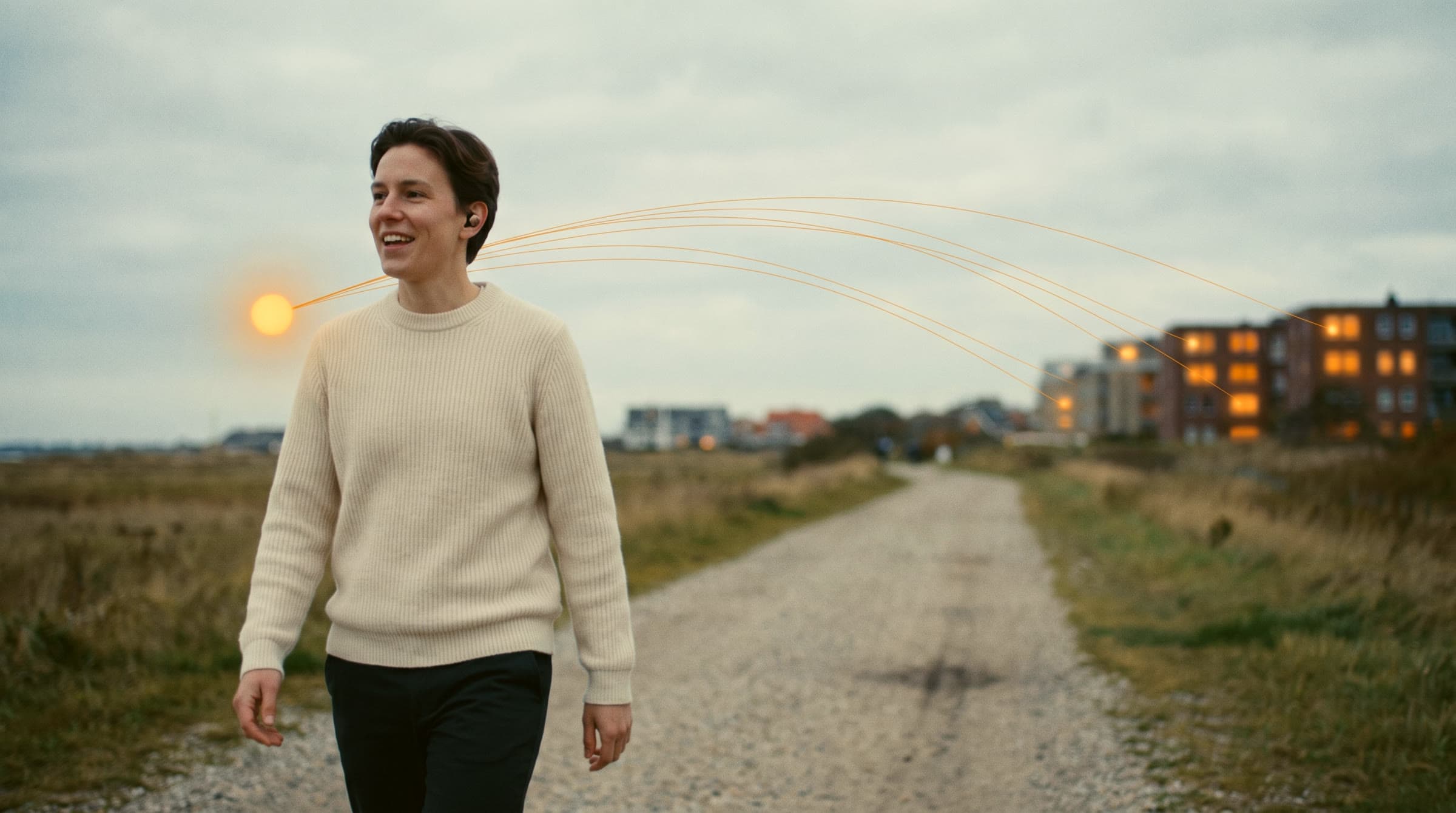 A person walks along a quiet path talking through an earbud, a small glowing orb of light beside them sending threads toward distant buildings with lit windows.
